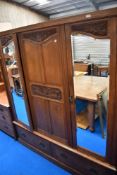 A Victorian oak triple wardobe having two mirror doors
