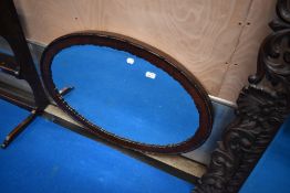 An early 20th Century mahogany oval mirror