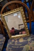 A small gilt frame wall mirror
