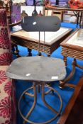 A vintage industrial work stool