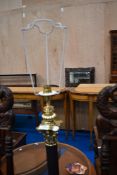 A standard lamp having brass bass, cornithian style column