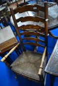 A traditional rush seated ladderback rocking chair