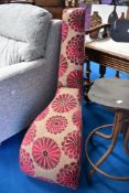 A modern upholstered chair modelled as a stiletto