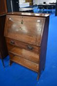 An Arts and Crafts style bureau with bookshelves under