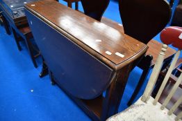 An early to mid 20th Century drop leaf dining table in the Sutherland style