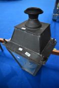 A traditional copper street lamp top