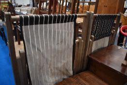 Two traditional deck chairs having black and white stripe seats
