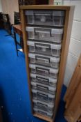 A laminate storage unit containing 10 A4 plastic storage containers containing a quantity of
