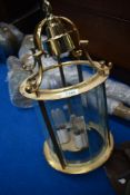 A modern brass ceiling light