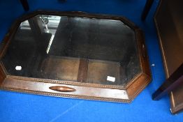 An early 20th century oak canted wall mirror