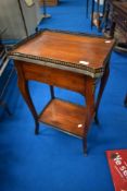 A reproduction side table having brass gallery