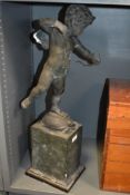 A 19th Century bronze effect figure of a cherub standing atop a tortoise, measuring 66cm tall