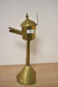 A primitive antique brass taper lighter or similar.