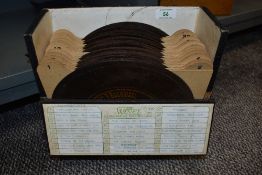 A collection of metal Phonograph 'discs' in a carry case.