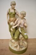 A Royal Dux figural group, depicting mother and father with child, , having pink lozenge to