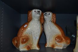 Two Staffordshire flat back spaniels, having inset glass eyes.