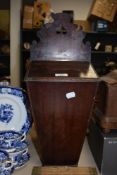A Georgian mahogany candle box, having a pierced and shaped top, measuring 50cm tall