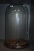 A Victorian glass dome, with ebonised base, measuring 39cm tall, the base with a diameter of 20cm