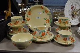A Crown Devon hand painted part tea service on yellow ground