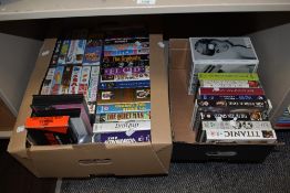 Two boxes of VHS tapes, including Titanic, The Eagle Has Landed, The Astronomers, and The Fifteen
