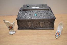 An Arts and Crafts wooden box, having embossed pewter overlay with coats of arms to sides, some