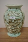 A moulded mint green Burleigh Ware vase, having Griffin and foliate decoration.