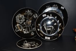 Four handpainted monochrome plates, signed D Bates