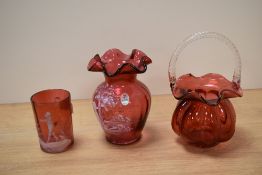 A 20th Century Fenton glass vase, of Mary Gregory style, a cranberry glass mug of similar style, and