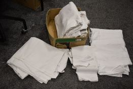 A collection of predominantly antique bed sheets, including linen sheets with drawn thread work