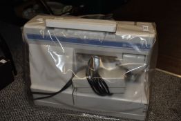 A Husqvarna sewing machine with manual.