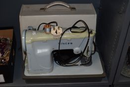 A vintage Singer sewing machine, model number 357K, with case.
