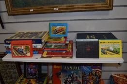 A shelf of vintage and modern Thomas The Tank Engine books.