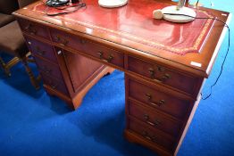 A reproduction Regency skiver top pedestal desk