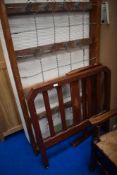 An early 20th Century single bed frame and a modern memory foam mattress