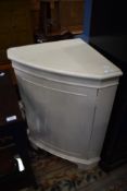 A painted corner cupboard base