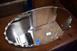 A vintage frameless wall mirror