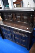 A vintage Priory or Ercol court cupboard