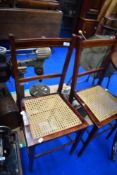A pair of Edwardian mahogany cane seated bedroom chairs