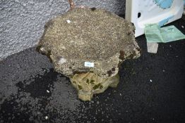 A concrete bird bath