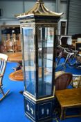 An Oriental pagoda style laquer and giltwork display cabinet with mother of pearl relief