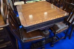 An early to mid 20th Century oak drawer leaf dining table and set of four railback chairs