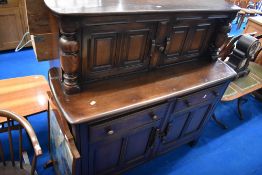 A dark stained Ercol court cupboard
