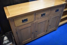 A modern golden oak sideboard