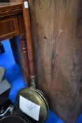 A traditional brass warming pan