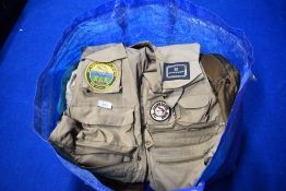 A bag of fishing clothing including waistcoats Nomad jacket and waxed jacket