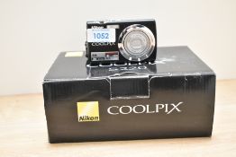A Nikon Coolpix S220 digital camera boxed with charger