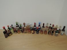 A box containing 30 miniature bottles of Sandemans Ruby Port, Johnnie Walker Red Label 70 proof,