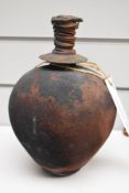 A spherical studio bottle with stopper, having textured finish, with Belgium label for Marc
