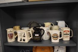 A collection of ceramic whisky and water pitchers, including Glengoyne, Glenfiddich, and The