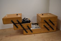 A mid century cantilever sewing box, containing assorted haberdashery.